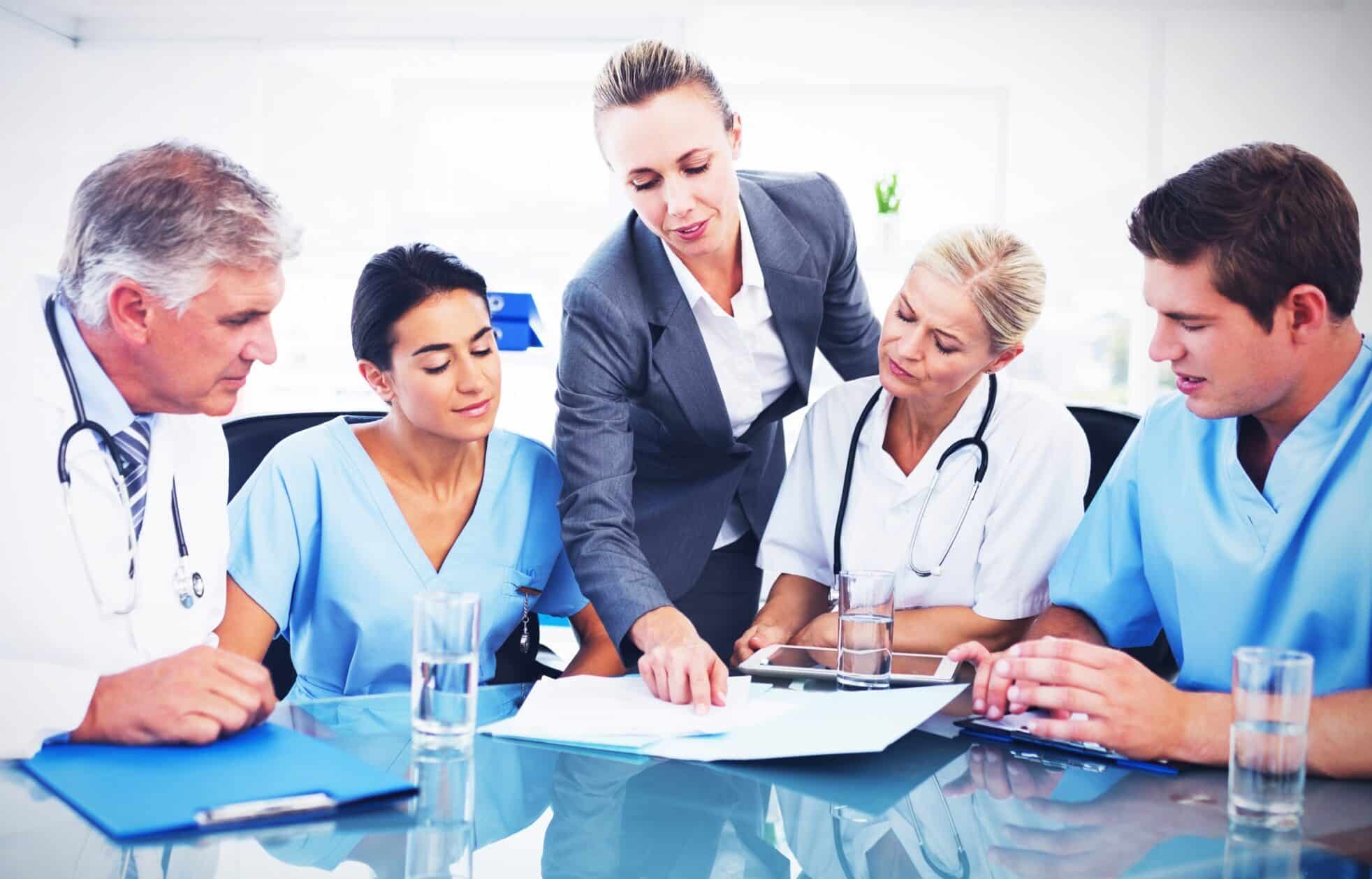 Team of doctors and businesswoman having a meeting