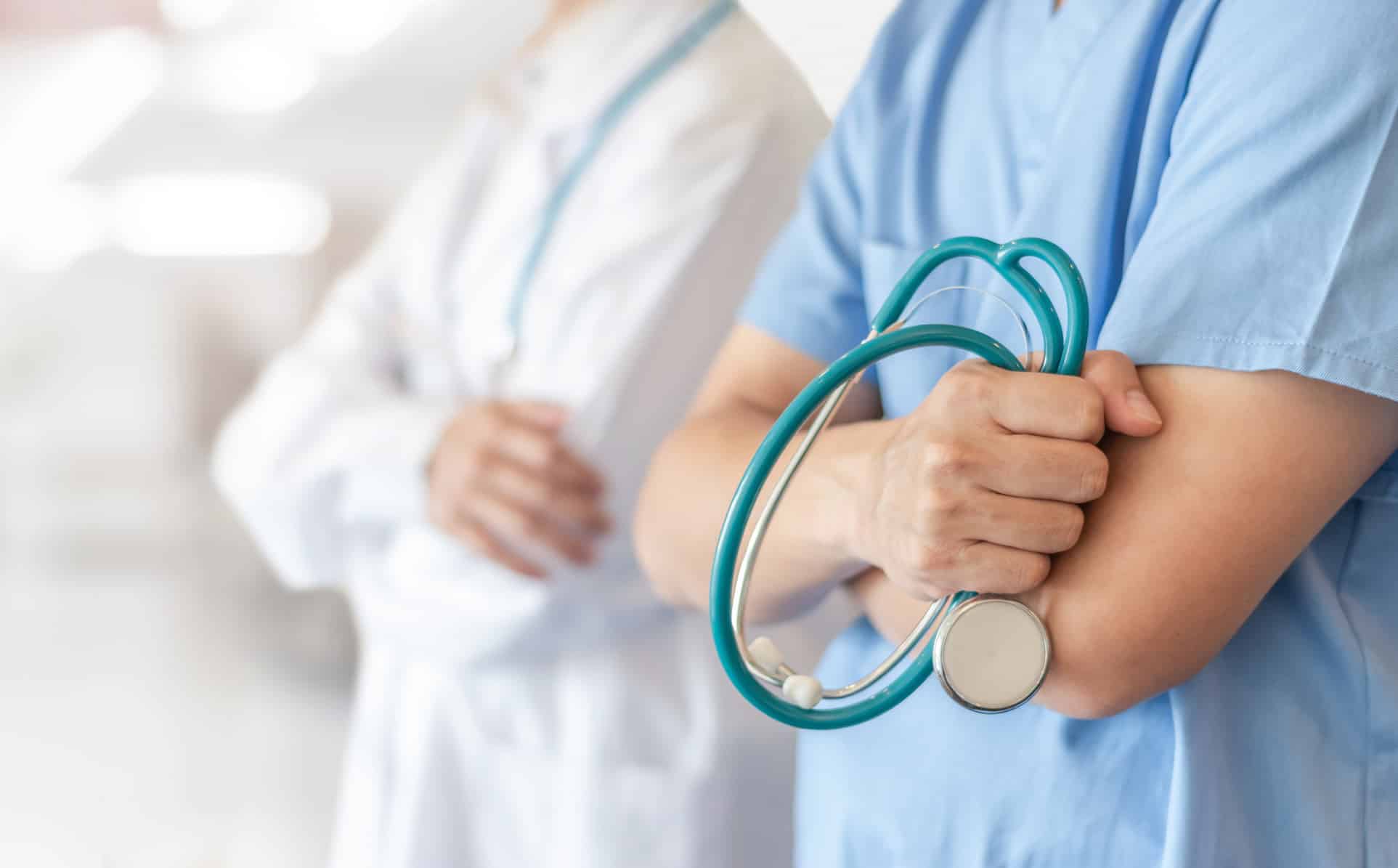 Surgeon and anesthetist doctor ER team with medical clinic room