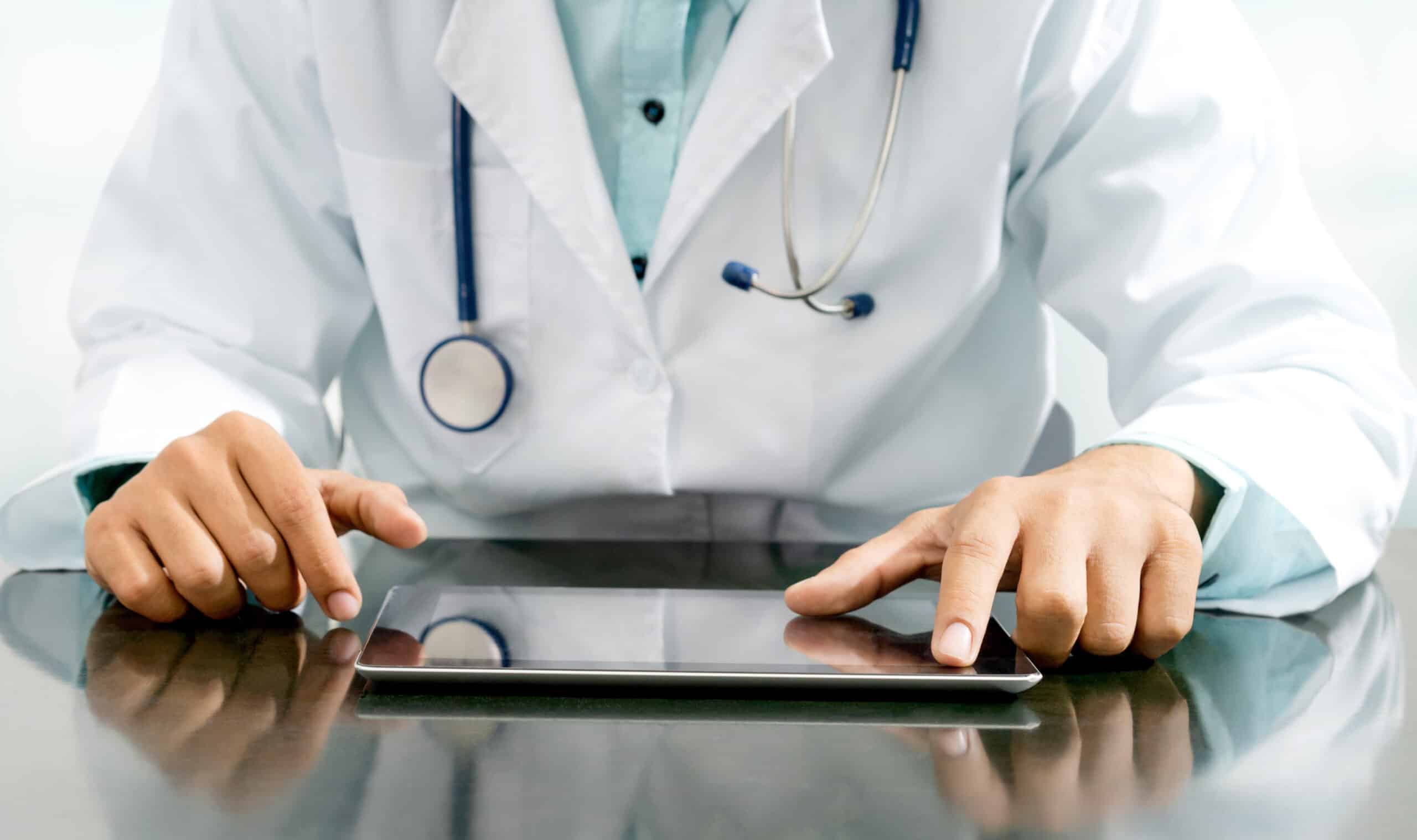 Doctor with tablet computer at hospital office.Doctor with tablet computer at hospital office.