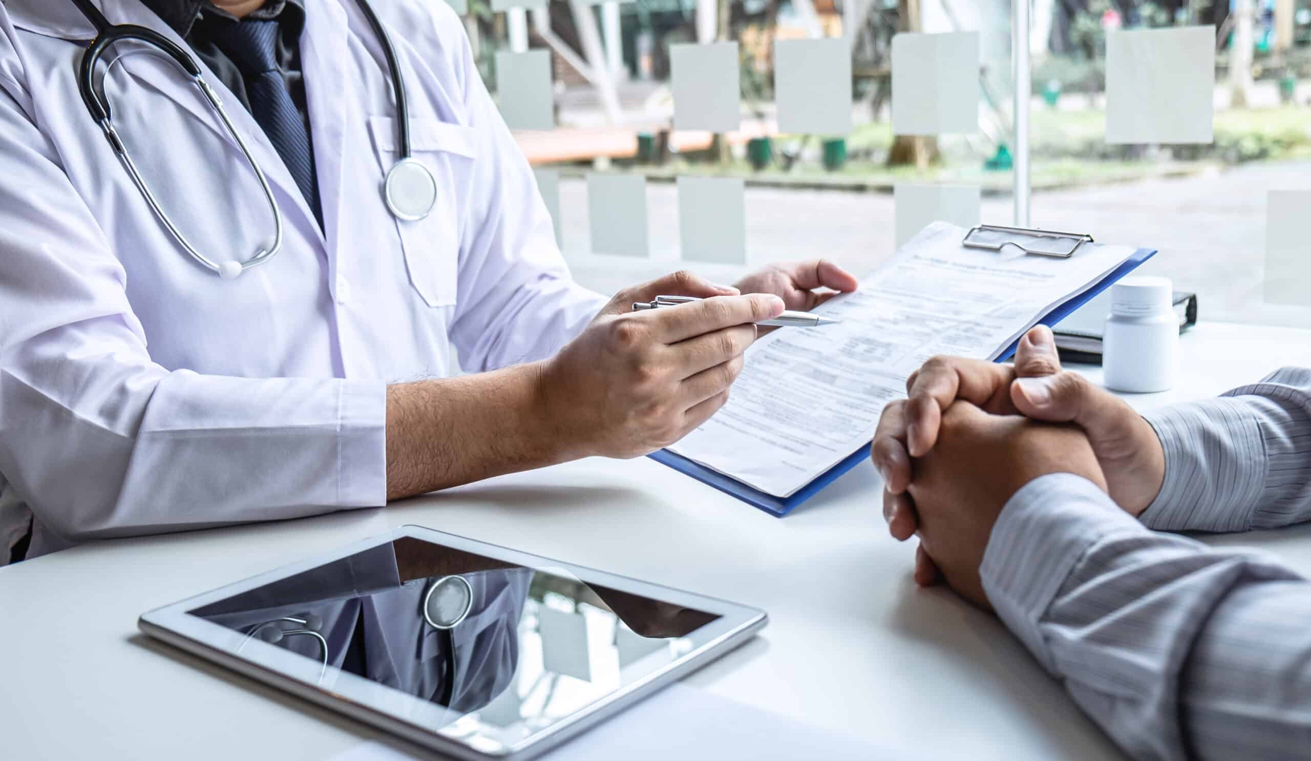 Doctor having conversation with patient while discussing explaining symptoms or counsel diagnosis health and consult