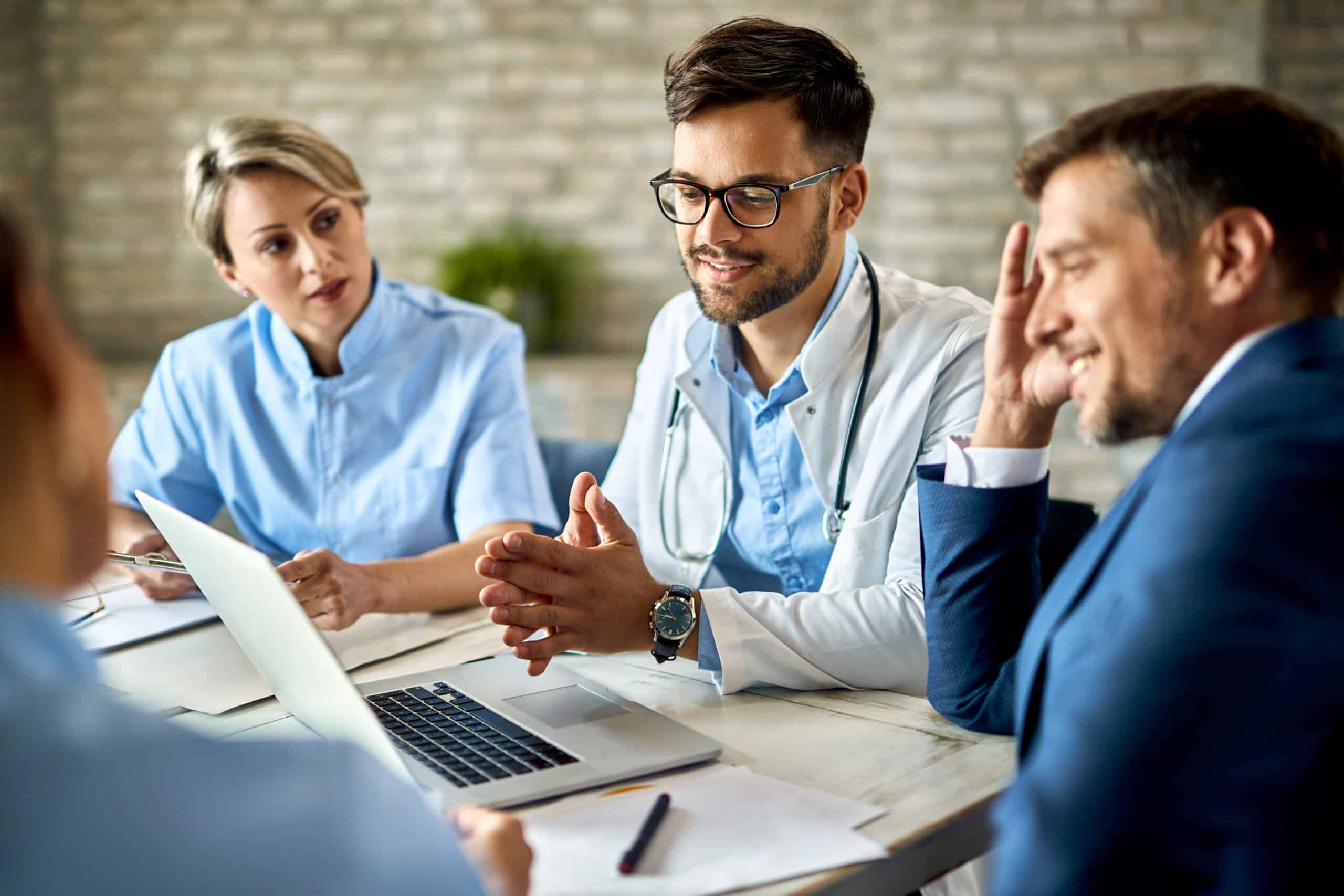 Team of doctors and businessman using computer during the meeting in the office.