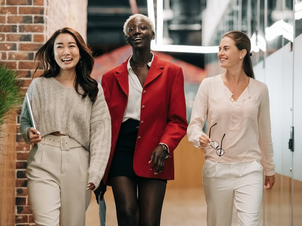 Women team members smiling and walking together